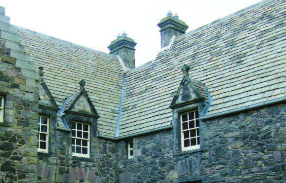A section of Acheson house stone slate roof and three dormer windows. 