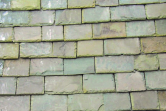 A close up of Acheson House stone slate roof in varying sizes and grey colours.