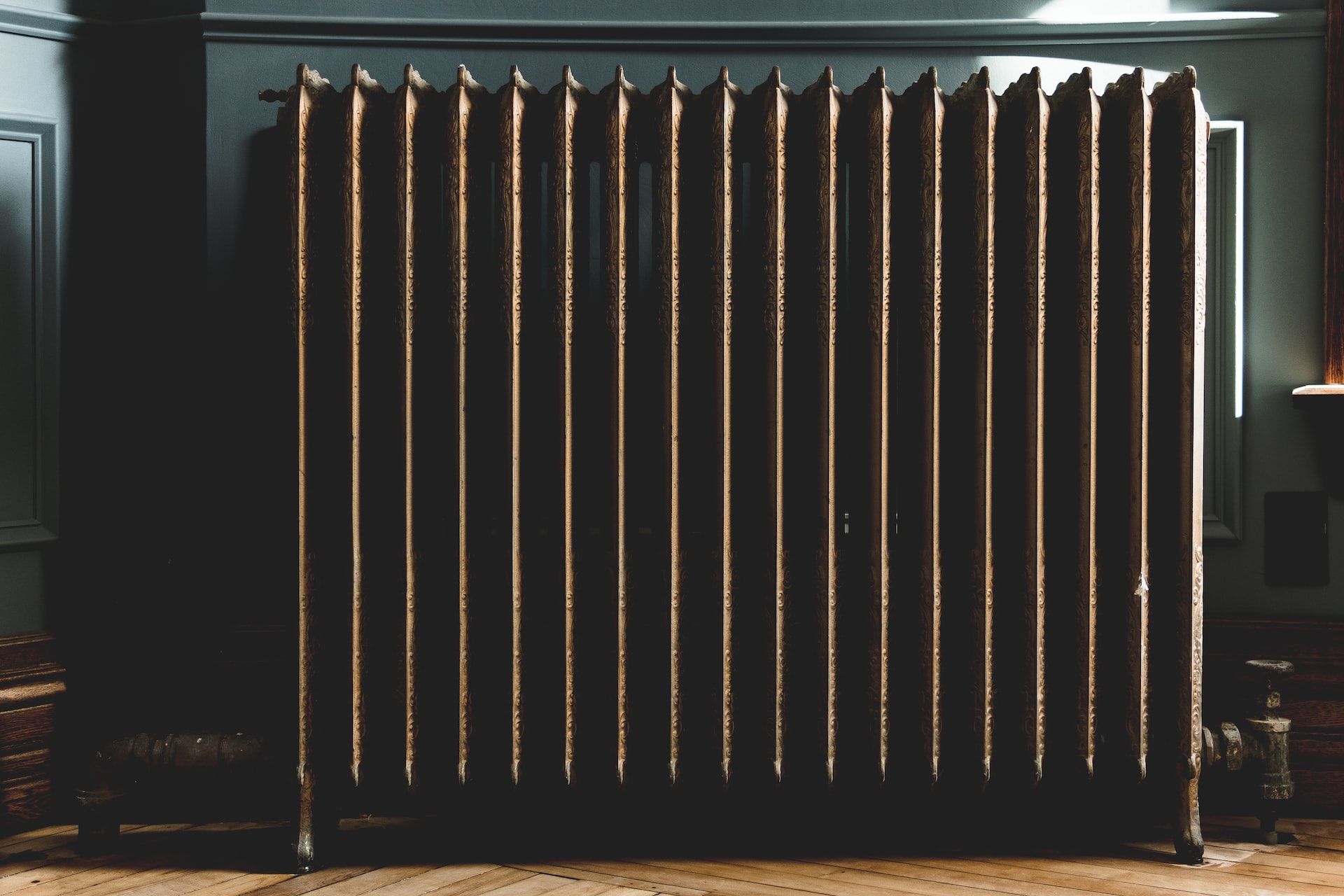An antique brass radiator in a home.