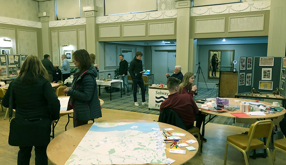 Tables with maps of Annan at the Climate Ready Annan event for visitors to map out their climate action aspirations.