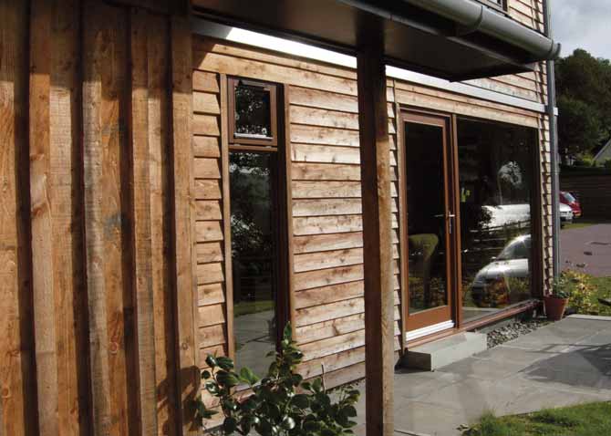 A close up of the Kilmun Housing exterior façade. The horizontal cladding boards have a rough-textured surface.