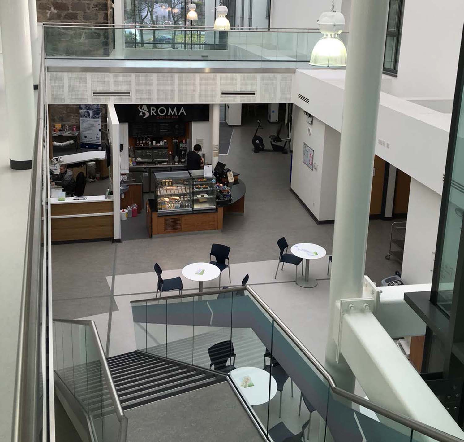 Looking down at Aberdeen Community Health and Care Village cafe and reception area in the atrium from the first floor.