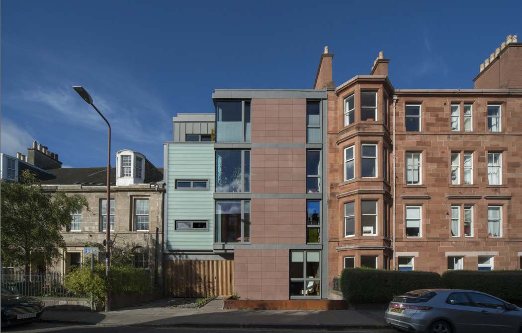 A modern four-storey block of flats in Portobello with a red sandstone façade and zinc cladding on the side walls.