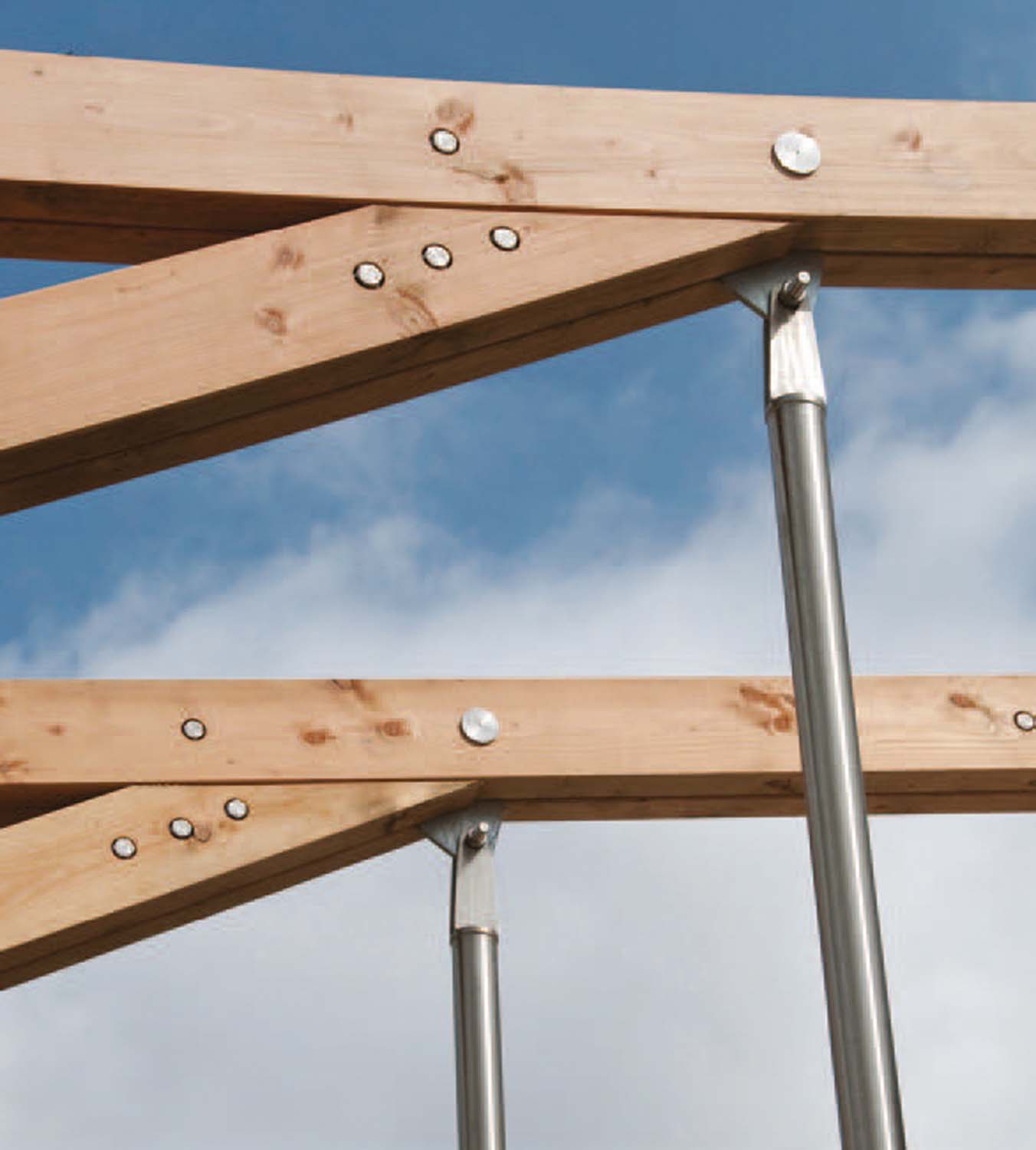 Two roof beams made of timber held up with a metal poles.