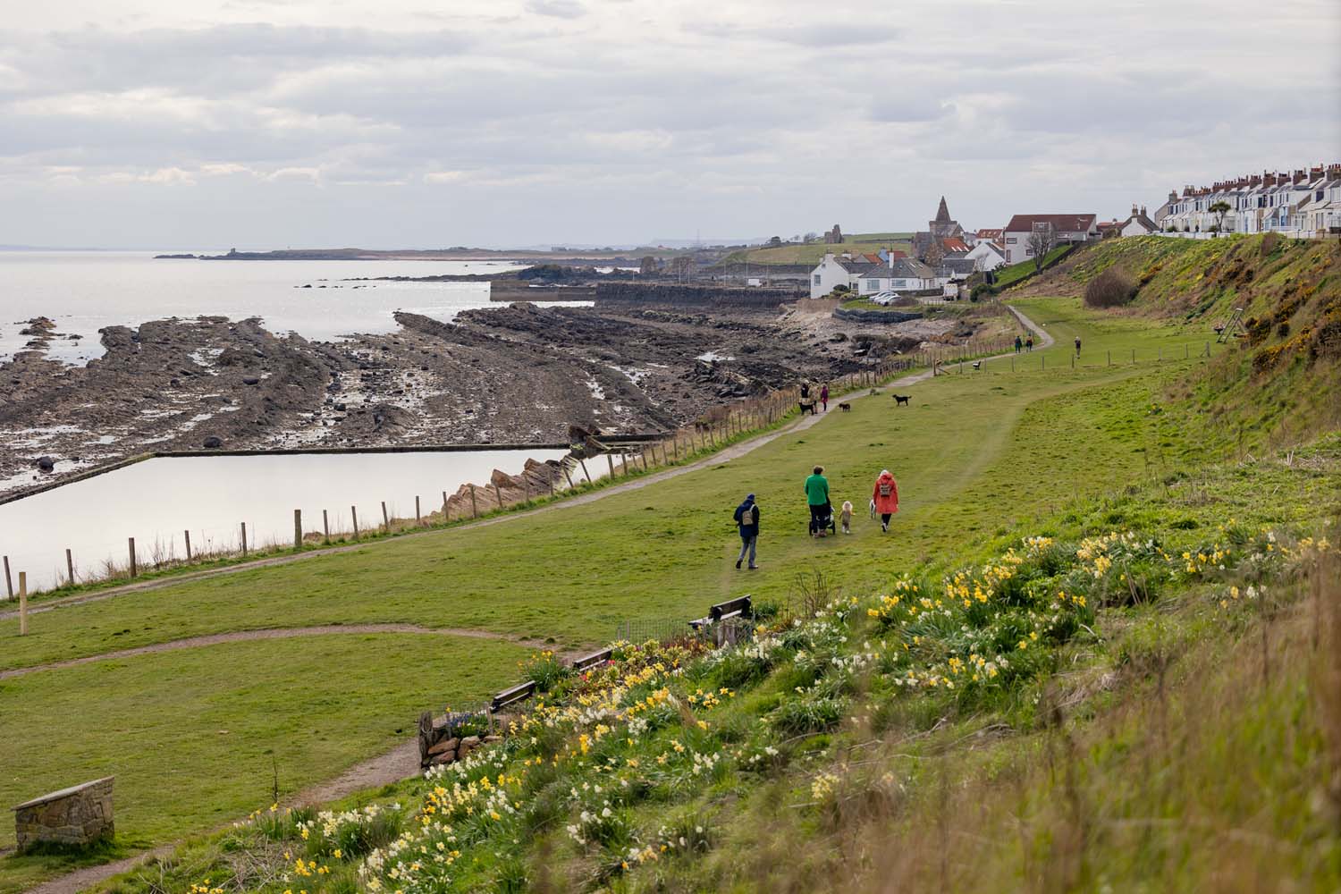 People walking along a sea coastal path at St Monans.