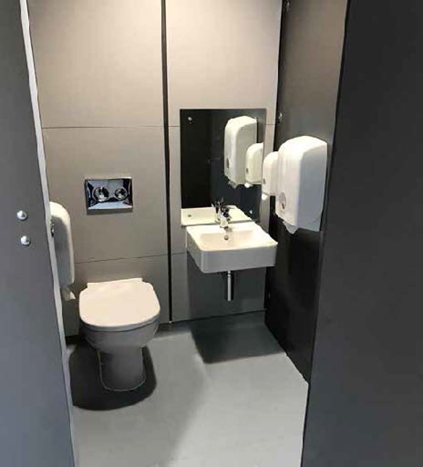 A toilet cubicle with an integrated wash-hand basin.