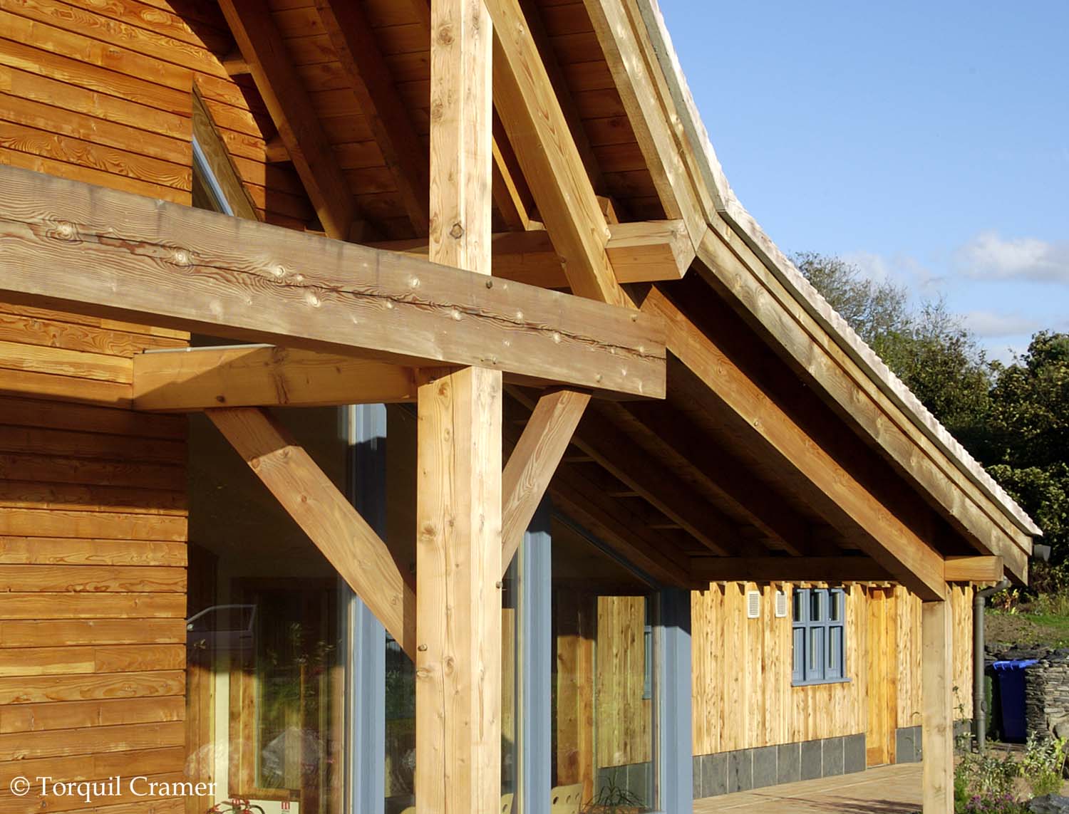 The structural frame that holds up the roof at Waterston house. The frame has a natural wood colour ranging between light and tan brown.