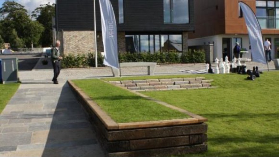 A photograph of a grassy area with a set of steps made from turf