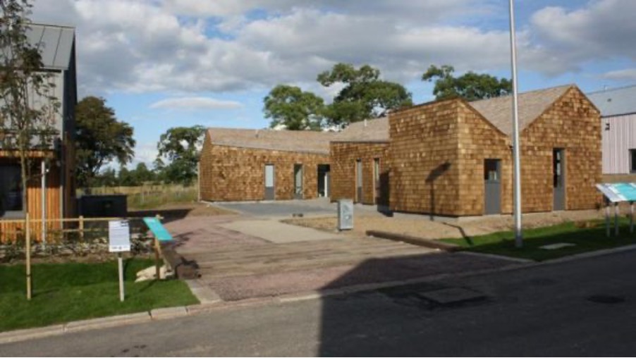 a photograph of a house clad with wooden shingles