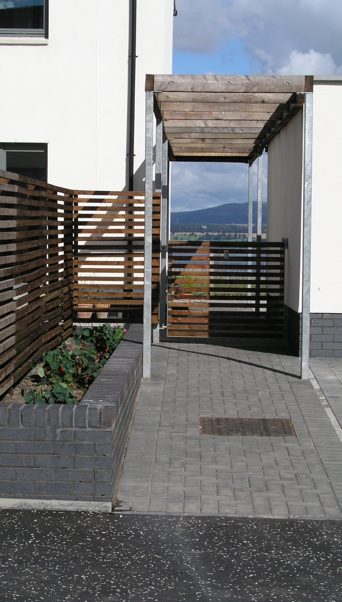 A side entry to a house in Maryfield housing with a timber pergolla detail. 