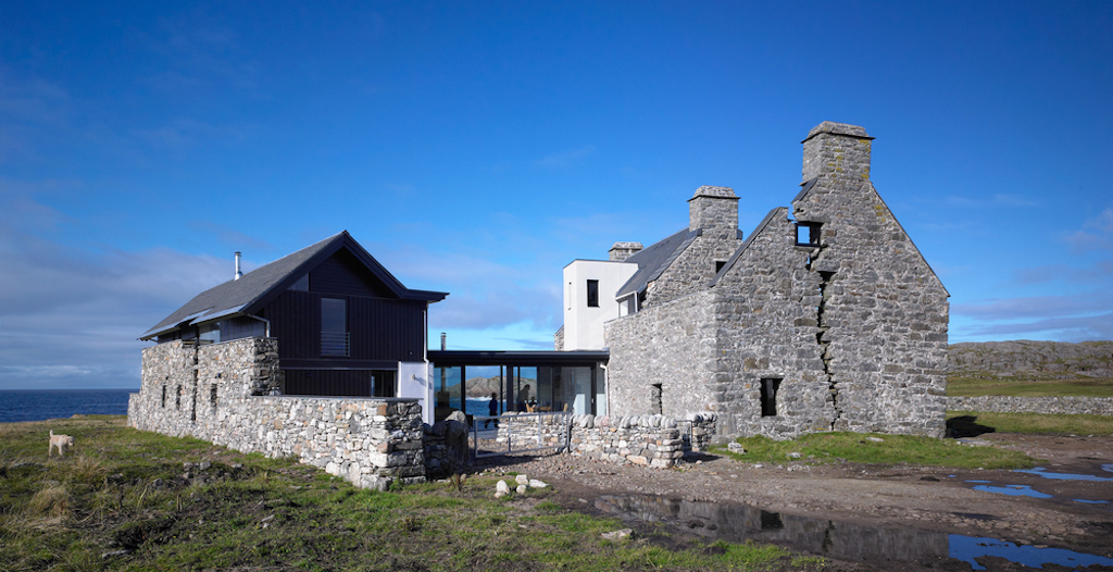 A two-storey stone house overlooking the sea on the Isle of Coll. 
