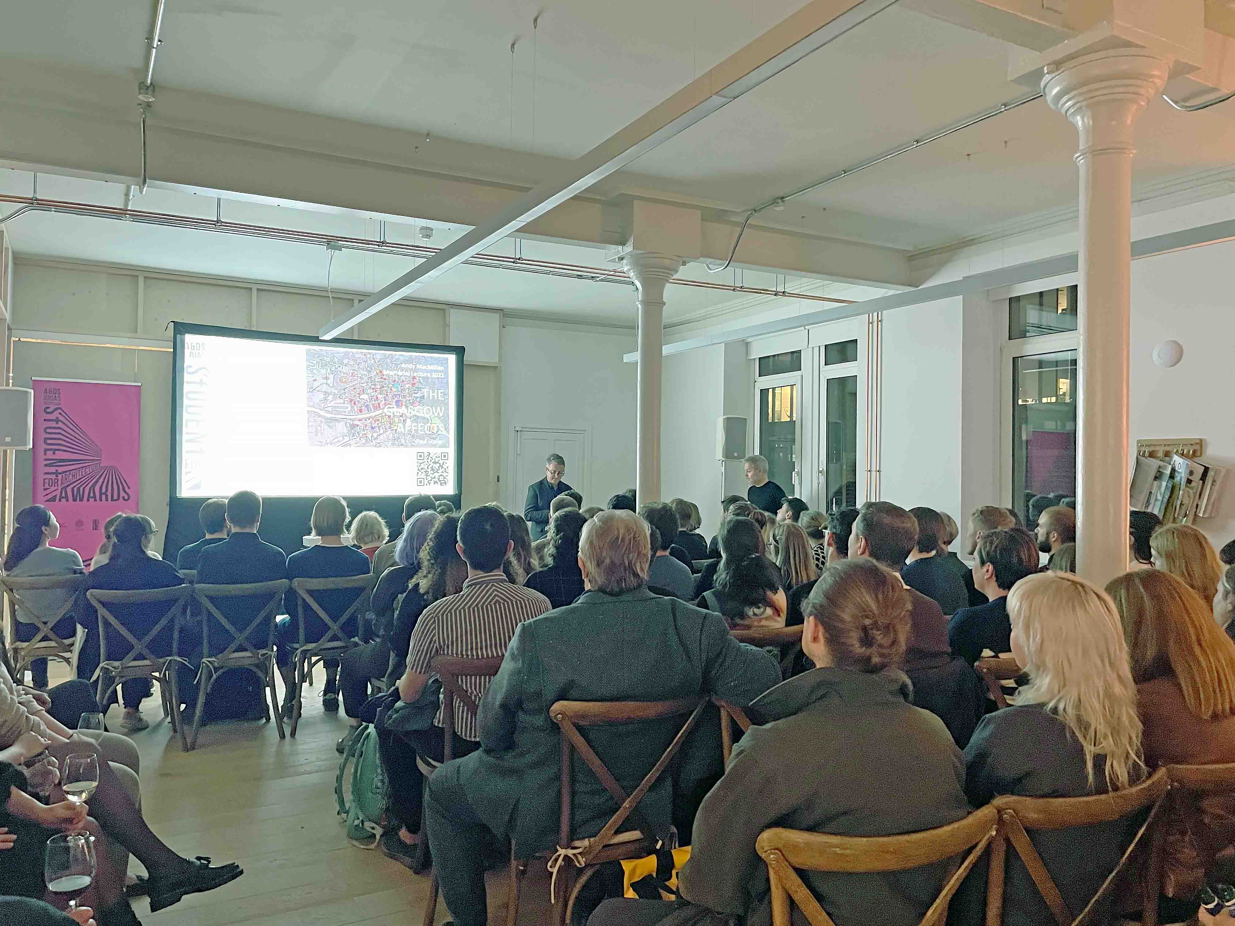 People sat in a lecture during the Andy MacMillan Memorial Lecture at Collective Architecture.