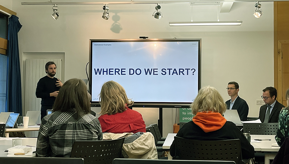 Joshua Doyle standing at the front of a conference room, presenting a slide 'Where do we start?" during LAUDF16.