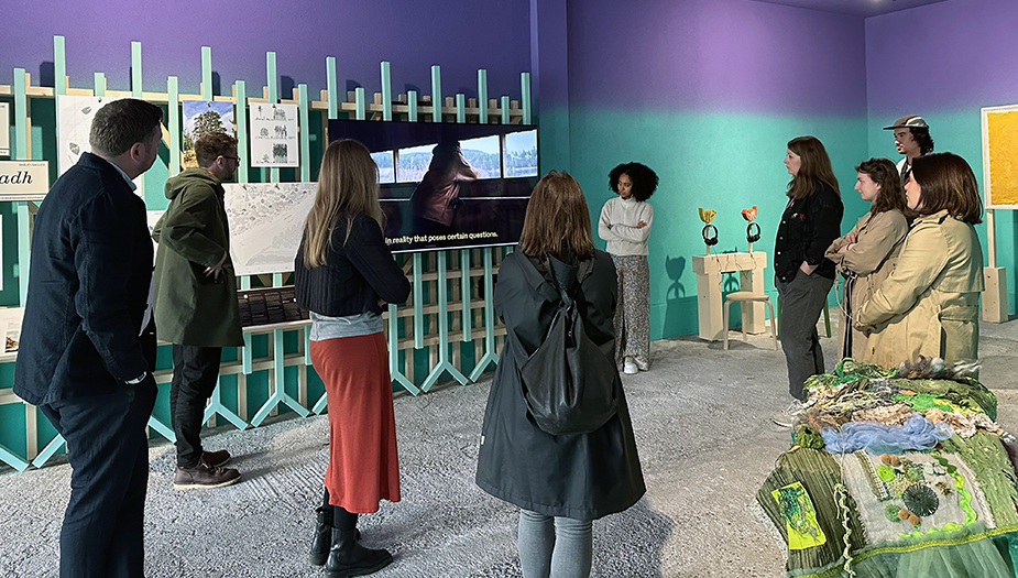 People watching the A Fragile Correspondence trailer at the La Biennale di Venezia exhibition space.