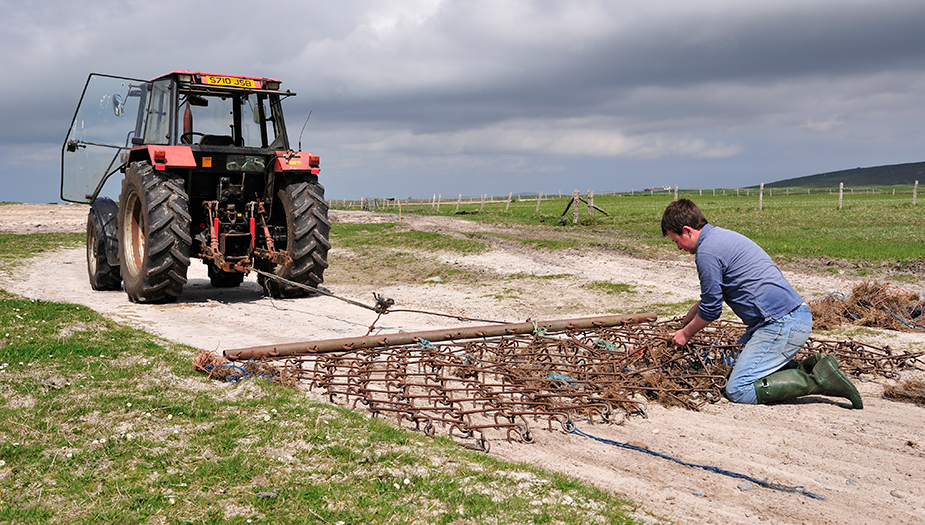 A man using a crofter and preparing to harrow.