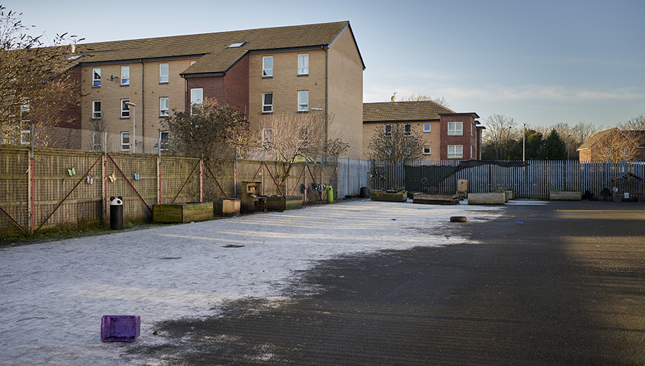 Snow covering a tarmac play area in a school ground at St Michaels Primary.