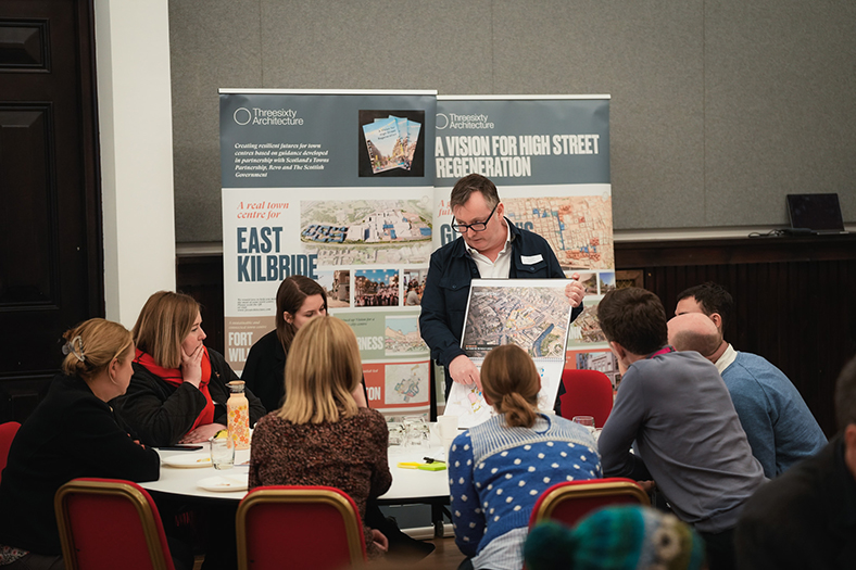 People sat around a table looking at a map in Paisley.