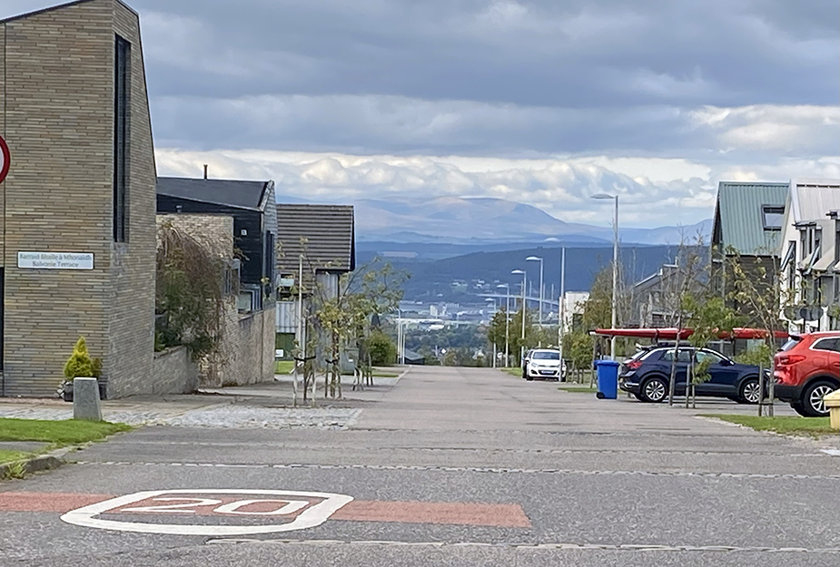 Housing area with ample carparking and mountains in the backdrop