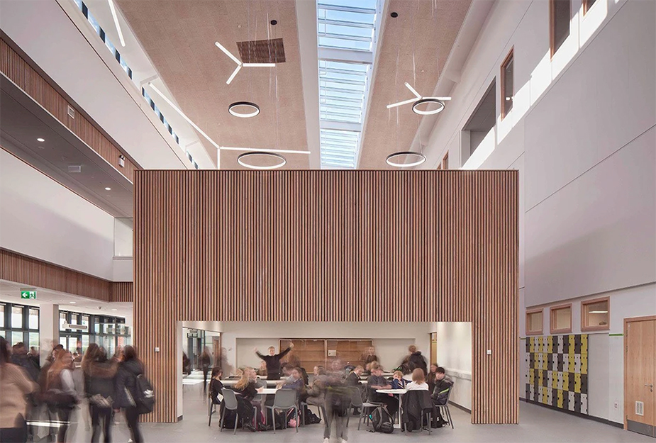 Image of open plan entrance area of school with a partition room in middle to break up space and create area for pupils to work within.