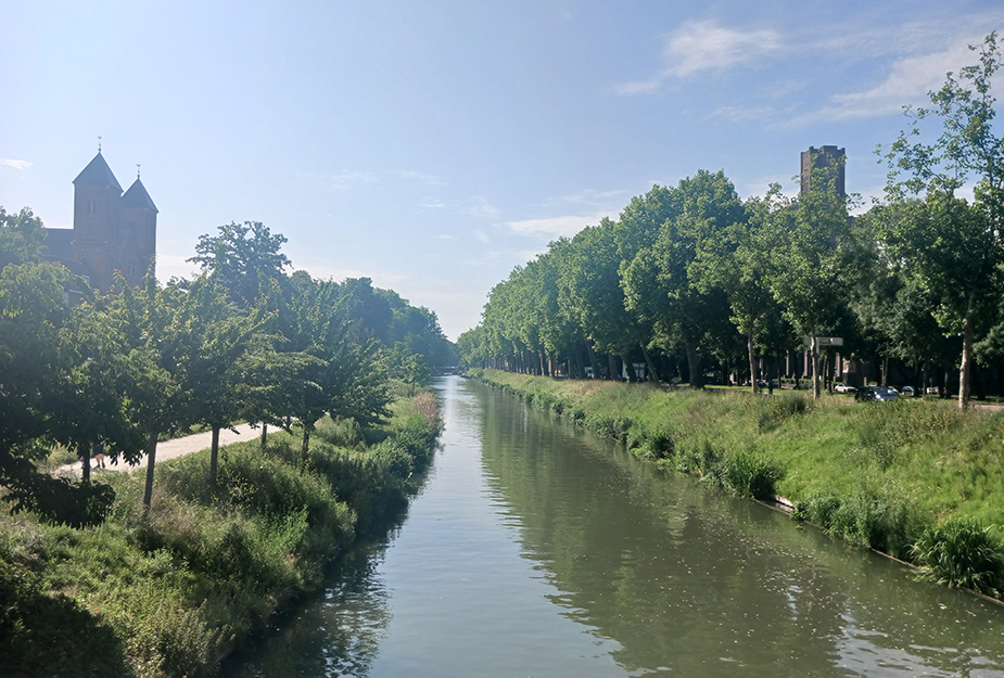 The historic canal with trees and grass and a canal walk/cycleway.