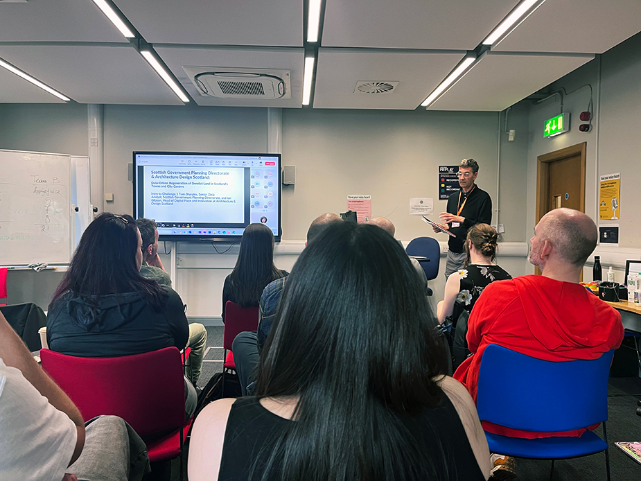 Ian Gilzean presenting to a group of people at the Data Lab Innovation Challenge 2025 at Edinburgh University.