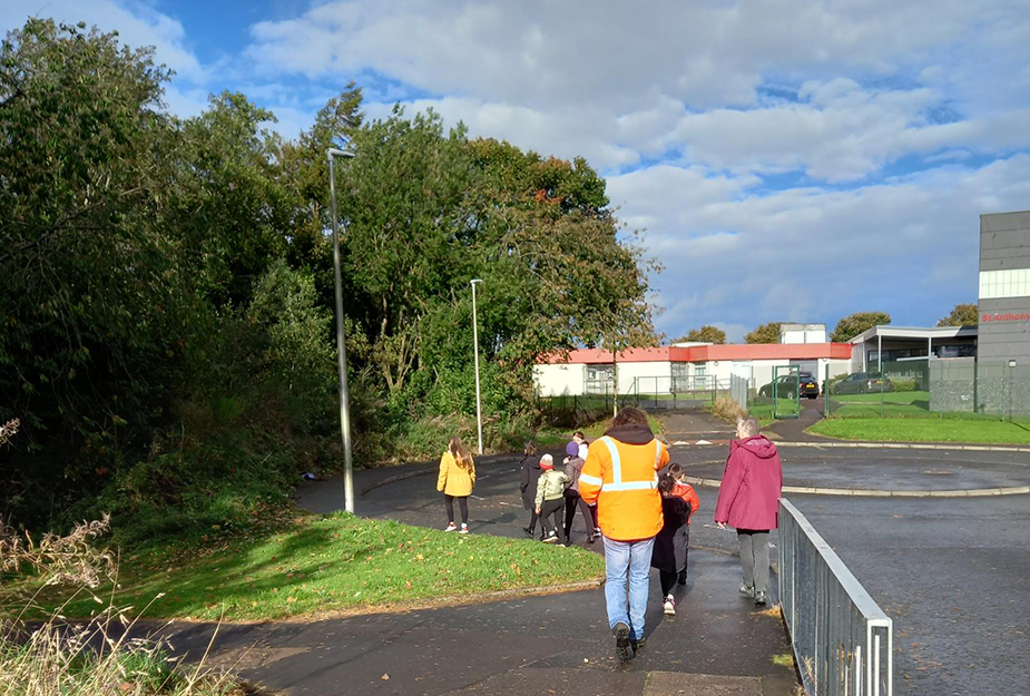 Pupils walking around learning about trees.