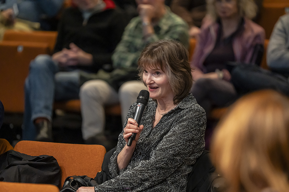 Member of the public asking a question to the panel at the AI in the City Public Forum.