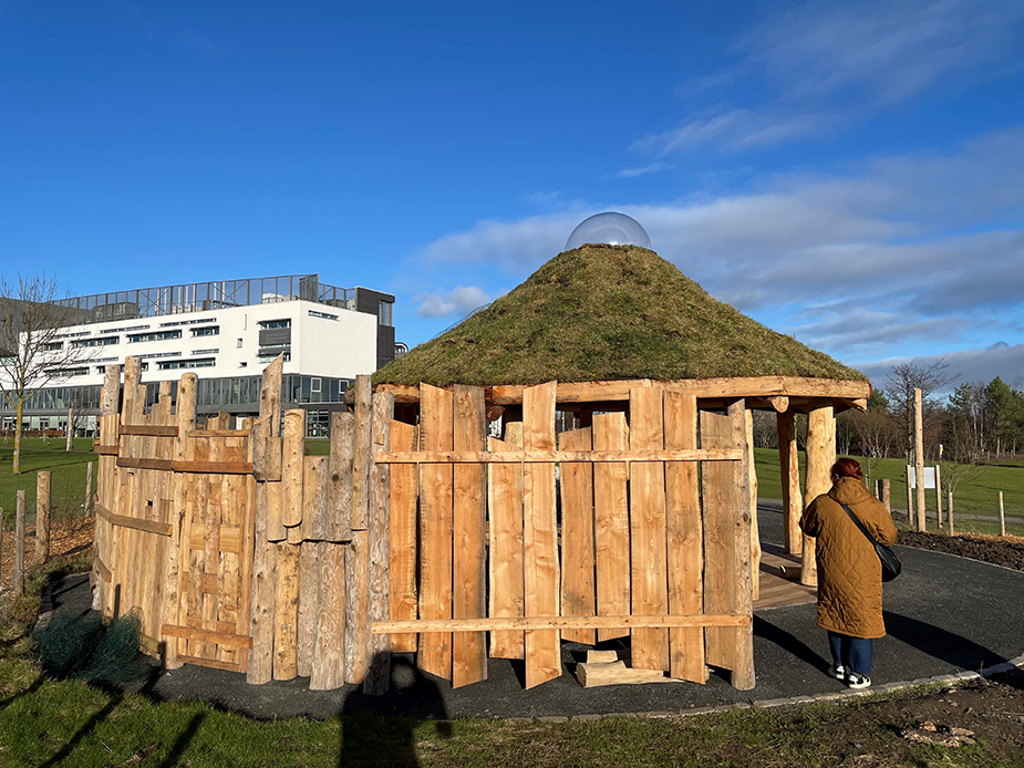 A person standing beside The Howff.