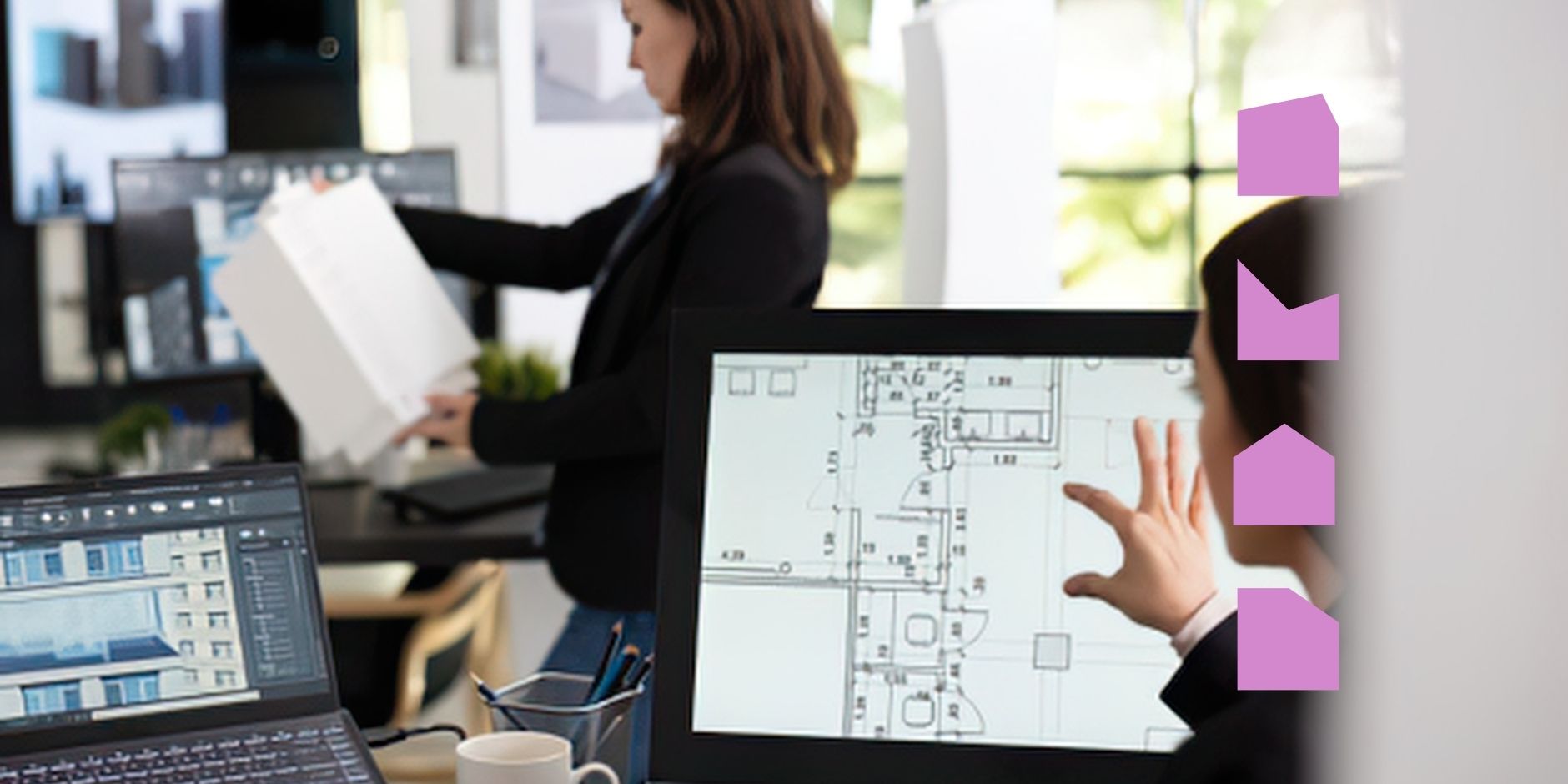 Image of person looking at a building plan on a screen in an office