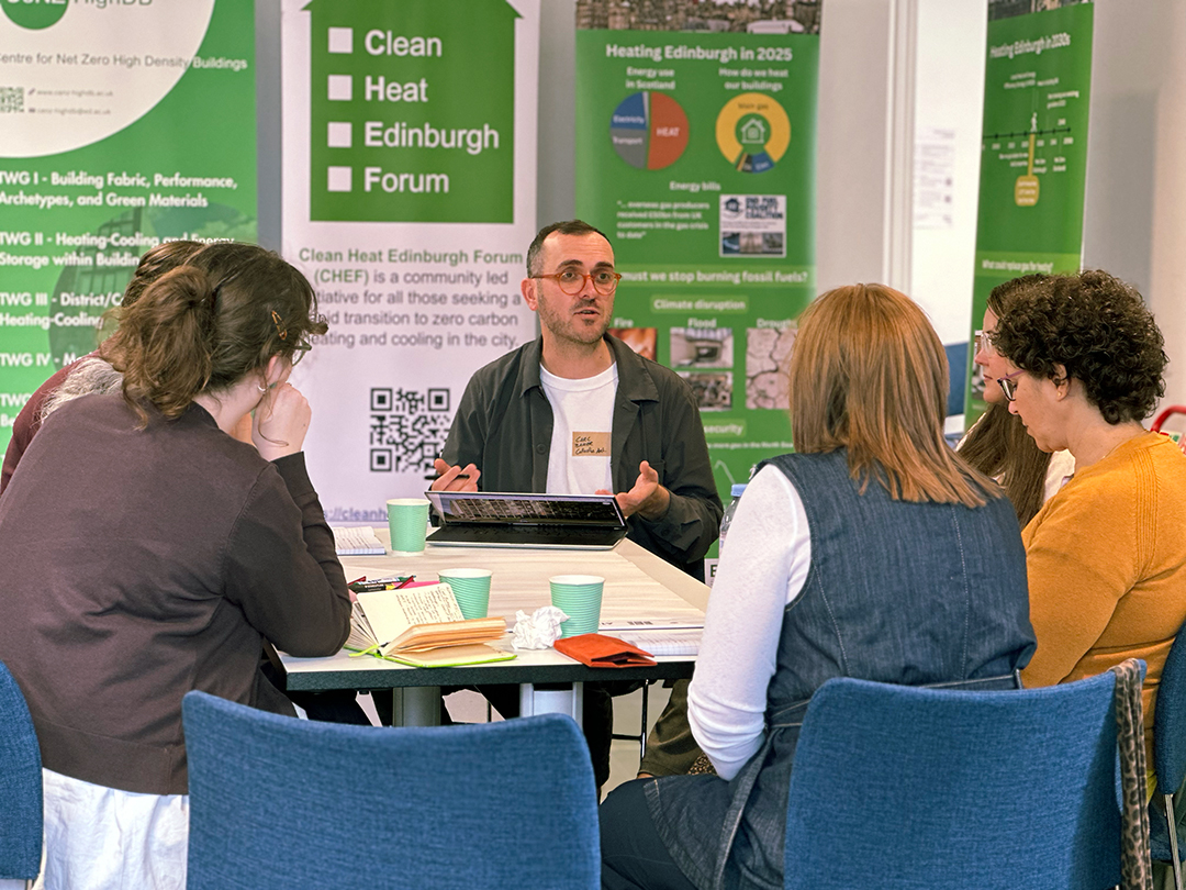 Carl Baker speaks to group of people at his table during Architecture and Design Scotland's Climate Clinic.