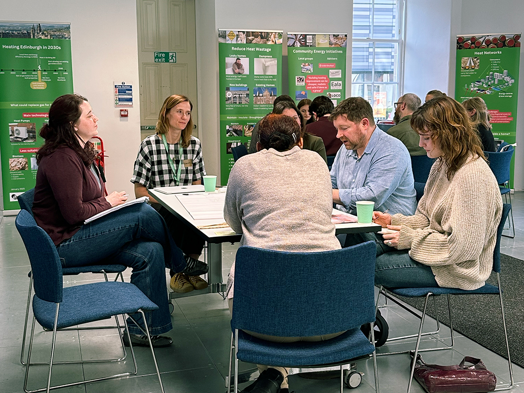 Chris Morgan speaks to a group of people at his table during Architecture and Design Scotland's Climate Clinic.