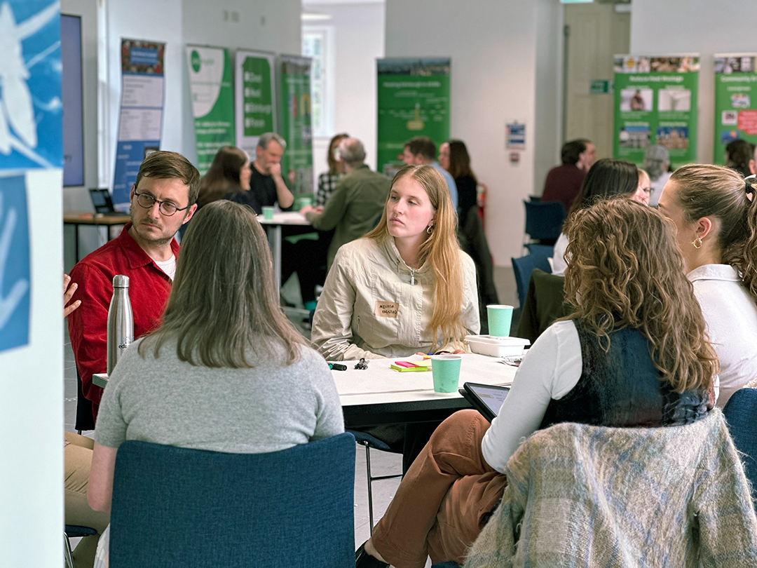 Rob Morrison listens intently to one of his participants at his table during Architecture and Design Scotland's Climate Clinic.