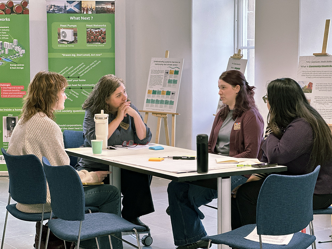 Sheena Raeburn, speaker at Architecture and Design Scotland's Climate Clinic event listens to event attendee during group discussion.
