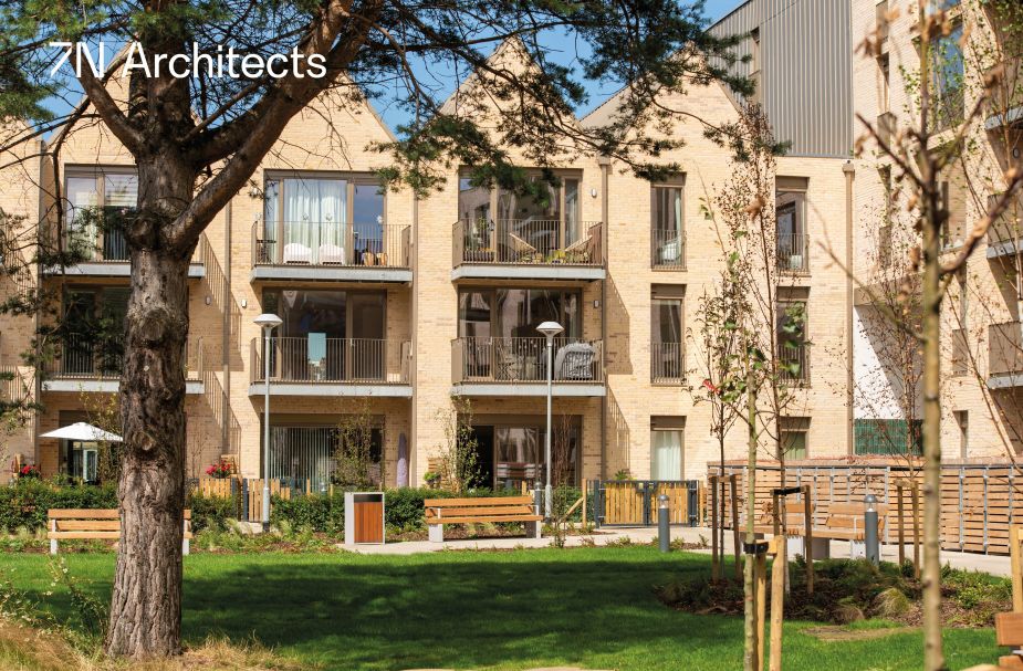 Modern three-storey residential blocks with protruding balconies.